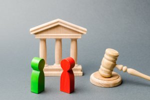 Wooden court house toys with gavel and red and green people figures