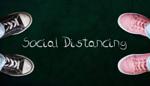 Chalk board with "social distancing" written on it