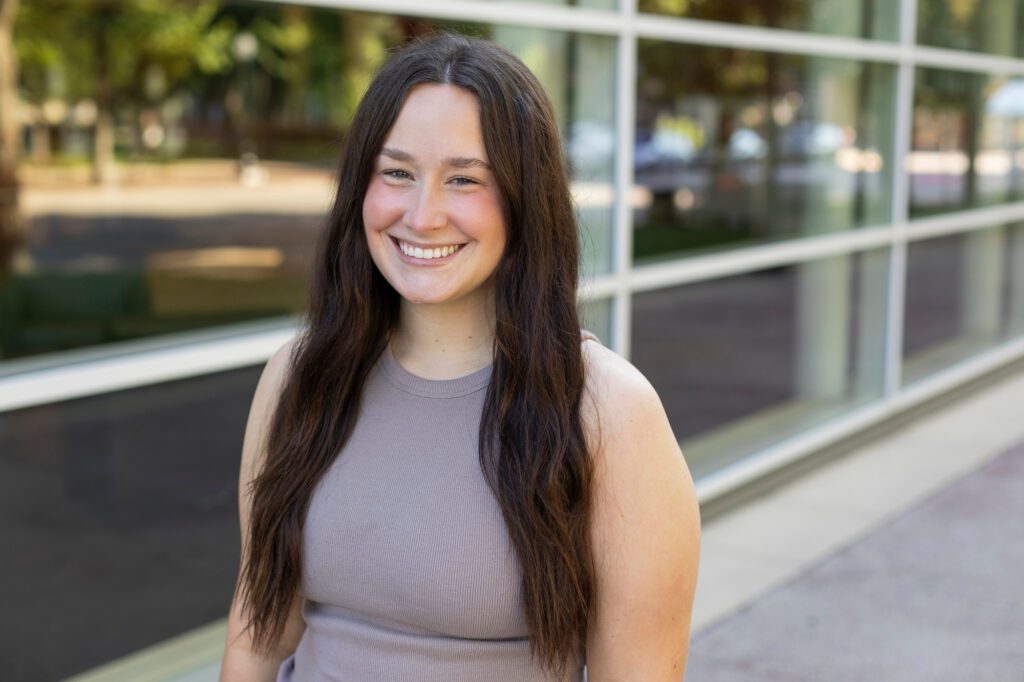 Legal Assistant - Colleen Yambar in front of building